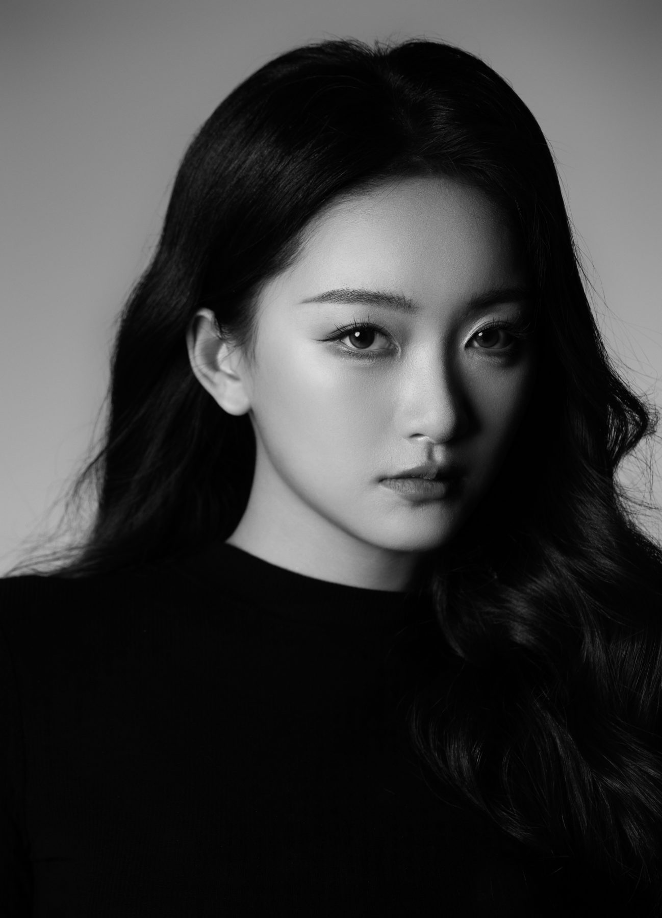 K9 Studio client black-and-white beauty portrait in a black top, soft studio lighting