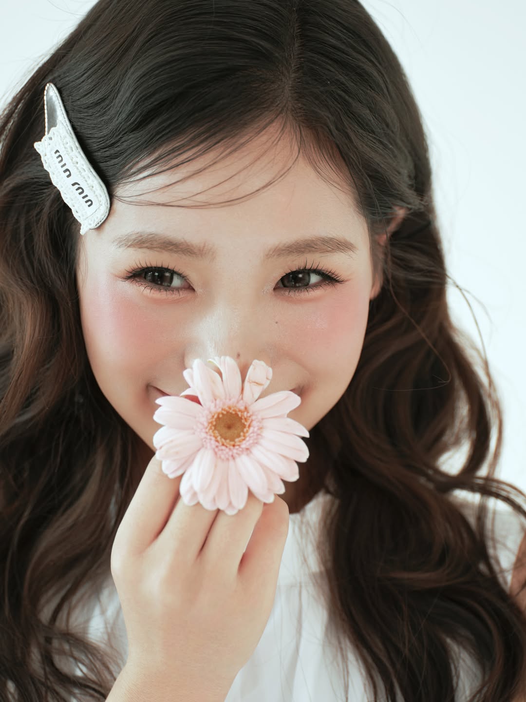 K9 Studio close-up portrait, holding a pink daisy near the chin
